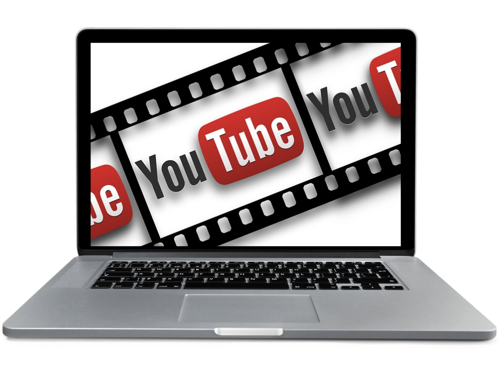 A laptop displaying the YouTube logo over a film strip background.